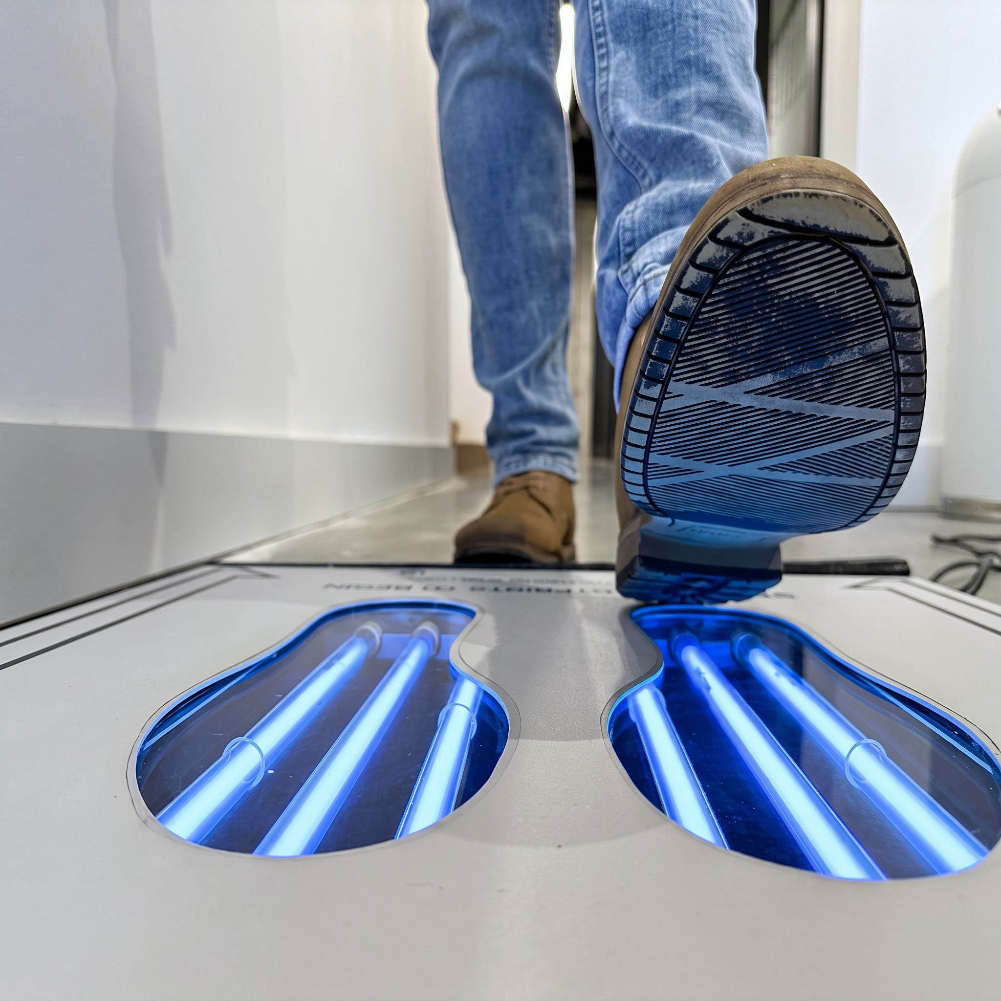 Both shoes positioned over the UVZone® treatment wells during the cycle